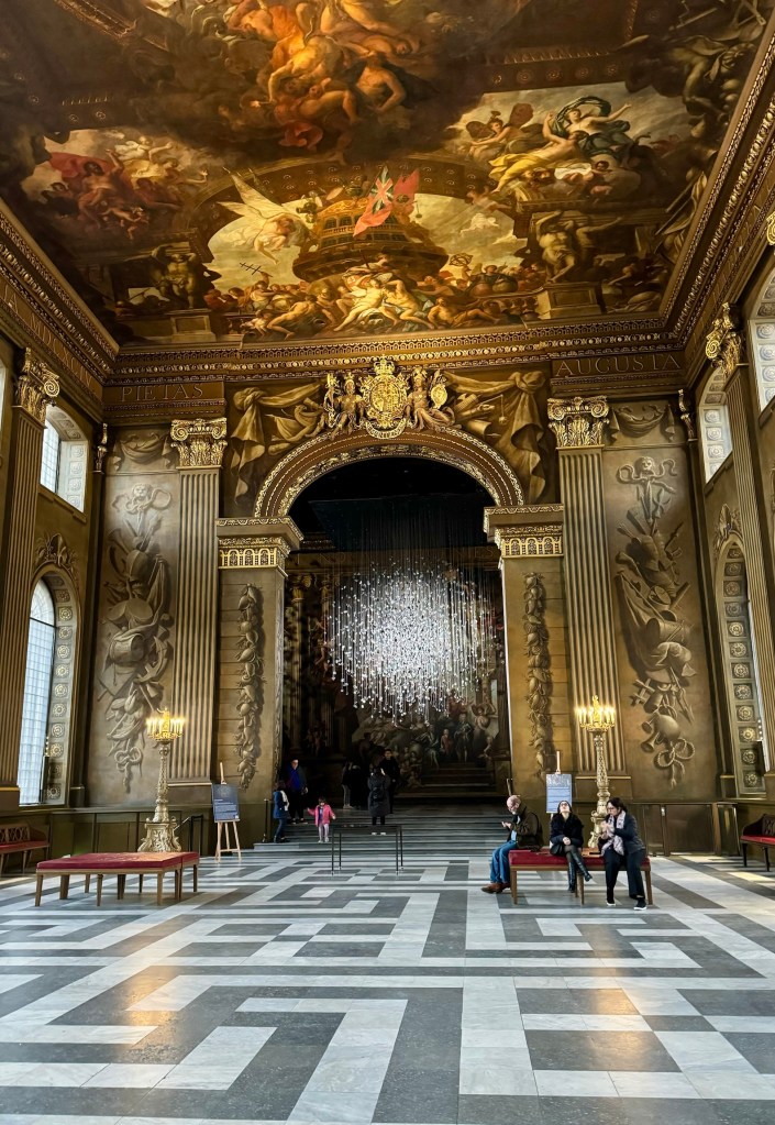 Coalescence -- an art display at Greenwich maritime museum. Light droplets hang like a loose sphere against the backdrop of classically painted ceiling and walls.